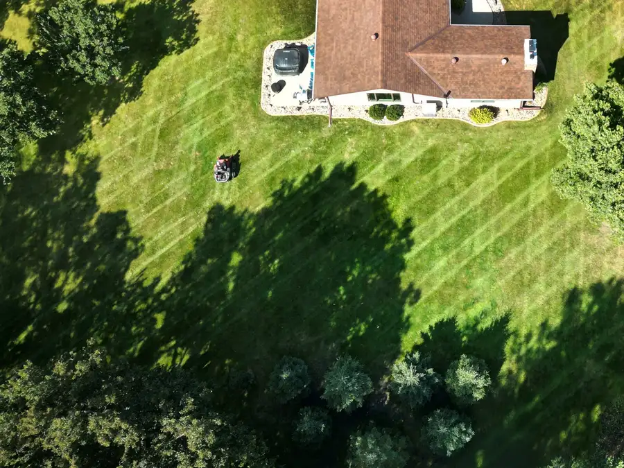 Aerial view of property showing clean lawn striping pattern